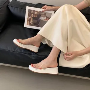 Detail view of women platform wedge transparent slide sandals, chic summer casual footwear.