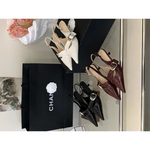 Women pointed toe slingback kitten heels with metal buckle and glossy patent leather upper.