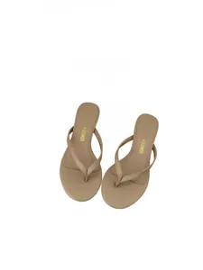 Close-up detail of stylish beige flip flops showing smooth strap design and comfortable insole.