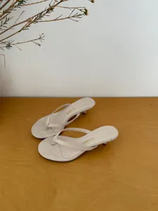 Beige kitten heel thong sandals featuring a minimalist design, perfect for summer casual wear.