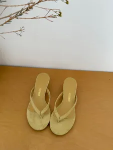 Detailed view of summer minimalist thong high heel sandals for women in elegant light yellow.