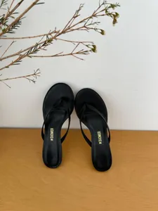 Minimalist black thong high heel sandals for women, stylish and comfortable summer footwear.