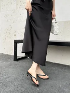 Black thong high heel mules detail showcasing a chic strap design and slender heel.