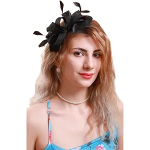 Black mesh fascinator detail with delicate feathers, elegant hair accessory for parties.