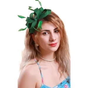 Detailed view of the elegant green fascinator with delicate feathers, perfect for party.