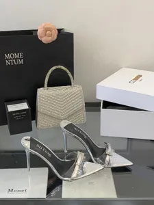 Silver metallic stiletto high heel mules with transparent strap and chic pointed toe design.