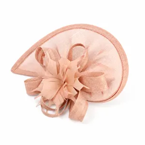 Detail shot of vintage pink fascinator hat with mesh and feather bow for wedding party.