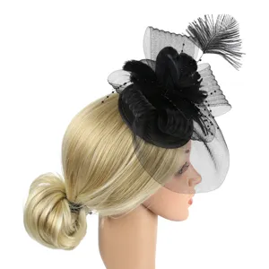 Detailed view of elegant black feather fascinator hat with mesh for wedding party events.