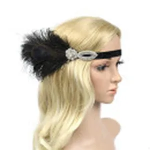 Detail shot of 1920s vintage black feather flapper headband with rhinestones for party wear.