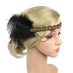 Close-up detail of vintage 1920s black feather flapper headband with beaded leaf and chain.