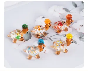 Detailed close-up shot of cute mini glass turtle figurines with colorful shells and tiny hats.