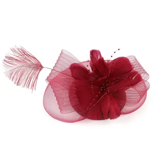 Elegant burgundy fascinator hat featuring delicate mesh, feathers, and beaded stems for parties.