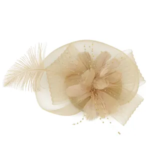 Detailed view of elegant champagne mesh feather fascinator hat for wedding and party.