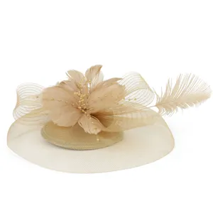 Close-up detail of elegant beige feather fascinator hat with delicate mesh and pearl bead decorations.