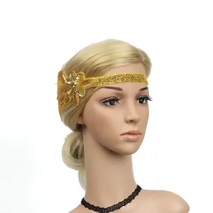 Vintage gold sequin flapper headband with beaded flower for 1920s party costume wear.