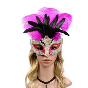 Detailed view of exquisite masquerade feather mask with pink and black feathers for party.