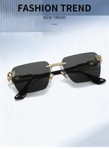Detailed view of rimless luxury sunglasses with gold metal hinges and black gradient lenses.