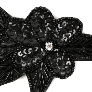 Black sequin beaded flower hair accessory detail view, elegant handmade rhinestone.