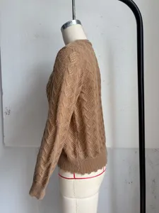 Detail shot of camel cable knit cropped cardigan sweater, side view showcasing texture.