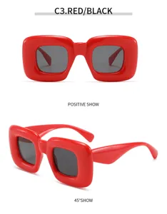 Detalle de unas gafas de sol cuadradas y abombadas rojas con estilo Y2K y urbano.