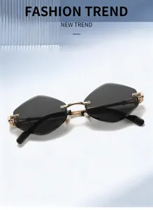 Close-up detail of stylish rimless polygon sunglasses with elegant gold metal bridge and dark lenses.