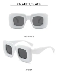 Vista detallada de gafas de sol Y2K abombadas, montura blanca audaz con lentes oscuras.