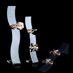 Close-up detail of acrylic S-shaped hair clip display stands showcasing elegant hair accessories.