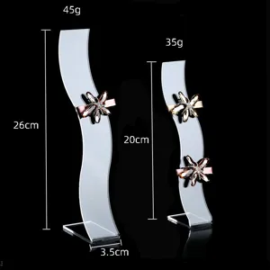 Clear acrylic S-shaped hairpin display stand with sparkling crystal hair clips for retail.