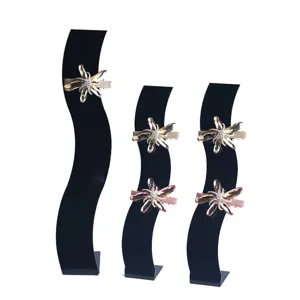 Acrylic S-shaped hairpin display stand with sparkling crystal hair clips for retail.