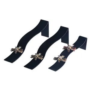 Acrylic S-shaped hairpin display stand detail showing black curve and crystal dragonfly ornament.