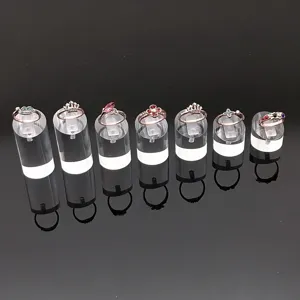 Detailed view of exquisite crystal diamond rings displayed on clear acrylic stands.