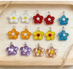 Colorful glass flower pendants, mini five-petal charms for DIY jewelry making and beading.