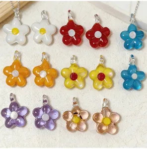 Colorful glass flower pendant close up, multi-color five-petal charm for DIY jewelry making.
