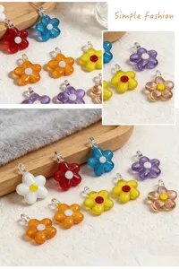 Close-up detail of colorful glass flower pendants, perfect for DIY jewelry and charm making.
