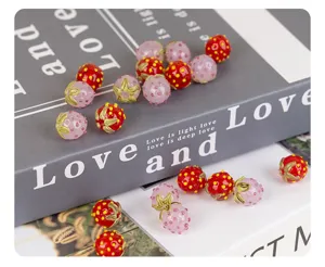 Handmade strawberry lampwork glass beads for DIY charm bracelets and jewelry accessories.