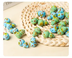 Detailed view of handmade glass gourd beads with blue swirl design for DIY jewelry making.