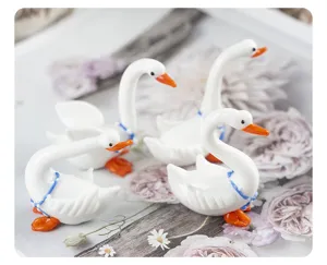 Glass white swan figurine detail shot, cute animal desktop decoration, fine craftsmanship.