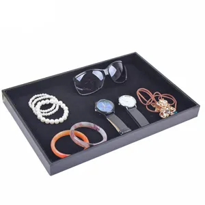 Black velvet jewelry display tray for rings, bracelets, watches, and accessories organizer.