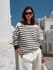 Detailed shot of casual striped knit top with contrasting cuffs and classic crewneck.