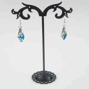 Blue crystal drop earrings displayed on a black metal stand, ideal for jewelry storage and retail.