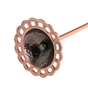Detailed close-up of a vintage copper-colored metal earring display stand component.