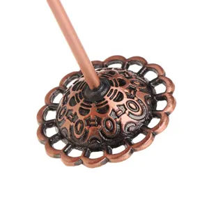 Vintage copper tone metal jewelry display rack detail component with carved pattern design.