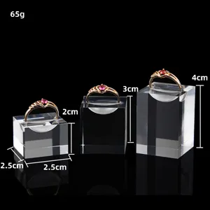 Transparent acrylic ring display stand set with three different heights for jewelry storage.