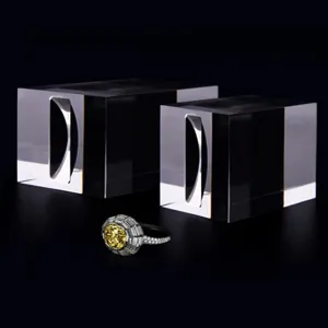 Detailed view of transparent acrylic ring display stands and exquisite yellow gemstone ring.