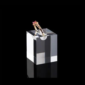 Clear acrylic ring display stand, transparent square jewelry holder for retail showcase detail.