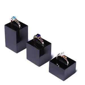 Acrylic ring display stand detail showing transparent jewelry organizer and black display blocks.