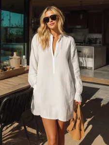 Minimalist white henley long sleeve shirt dress for casual summer resort wear and daily use.