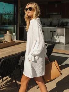 Detail shot of a minimalist white henley loose shirt dress styled in a modern kitchen setting.