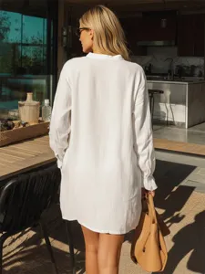 Detail shot of the white Henley shirt, showcasing loose long sleeves and resort style.