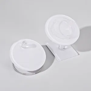 Clear acrylic bracelet display stand with white tray for jewelry photography and showcasing.